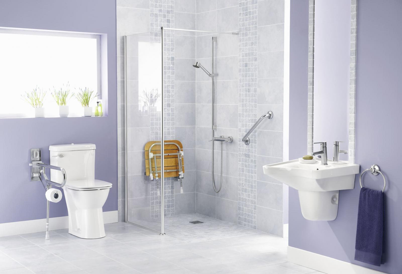 Image of bathroom with bathroom safety products like grab bars and shower seat installed